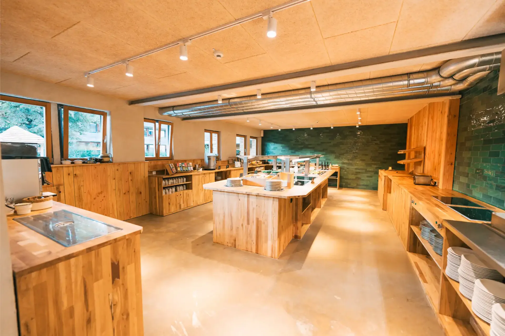 Seating area with wooden tables in the Gut Hügle family restaurant