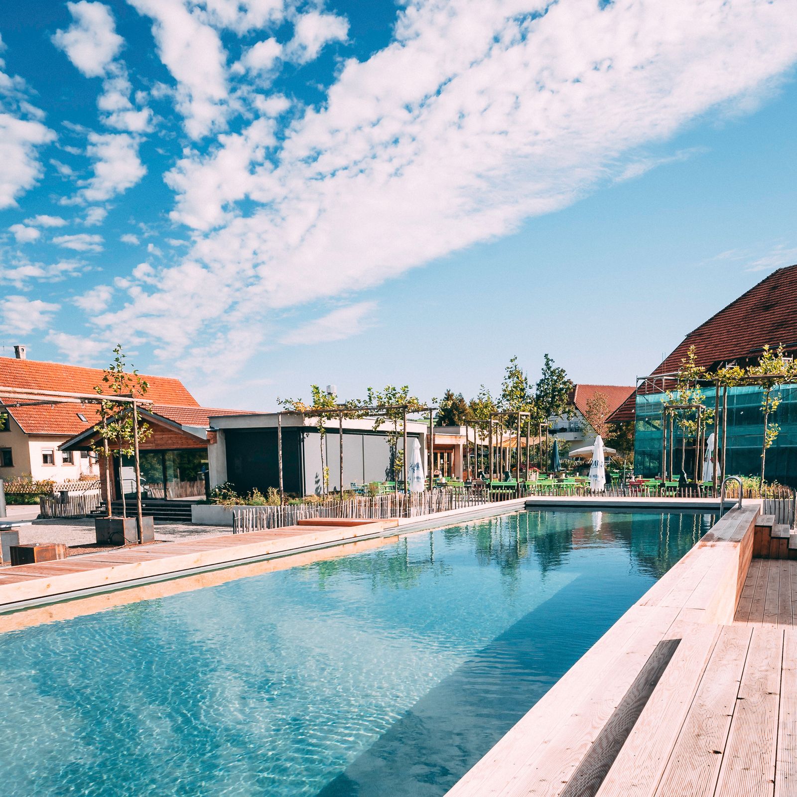 Outdoor area at the adventure farm with pool and farm buildings